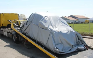 Vehicle on an inclined towing surface with a VLITEX cover